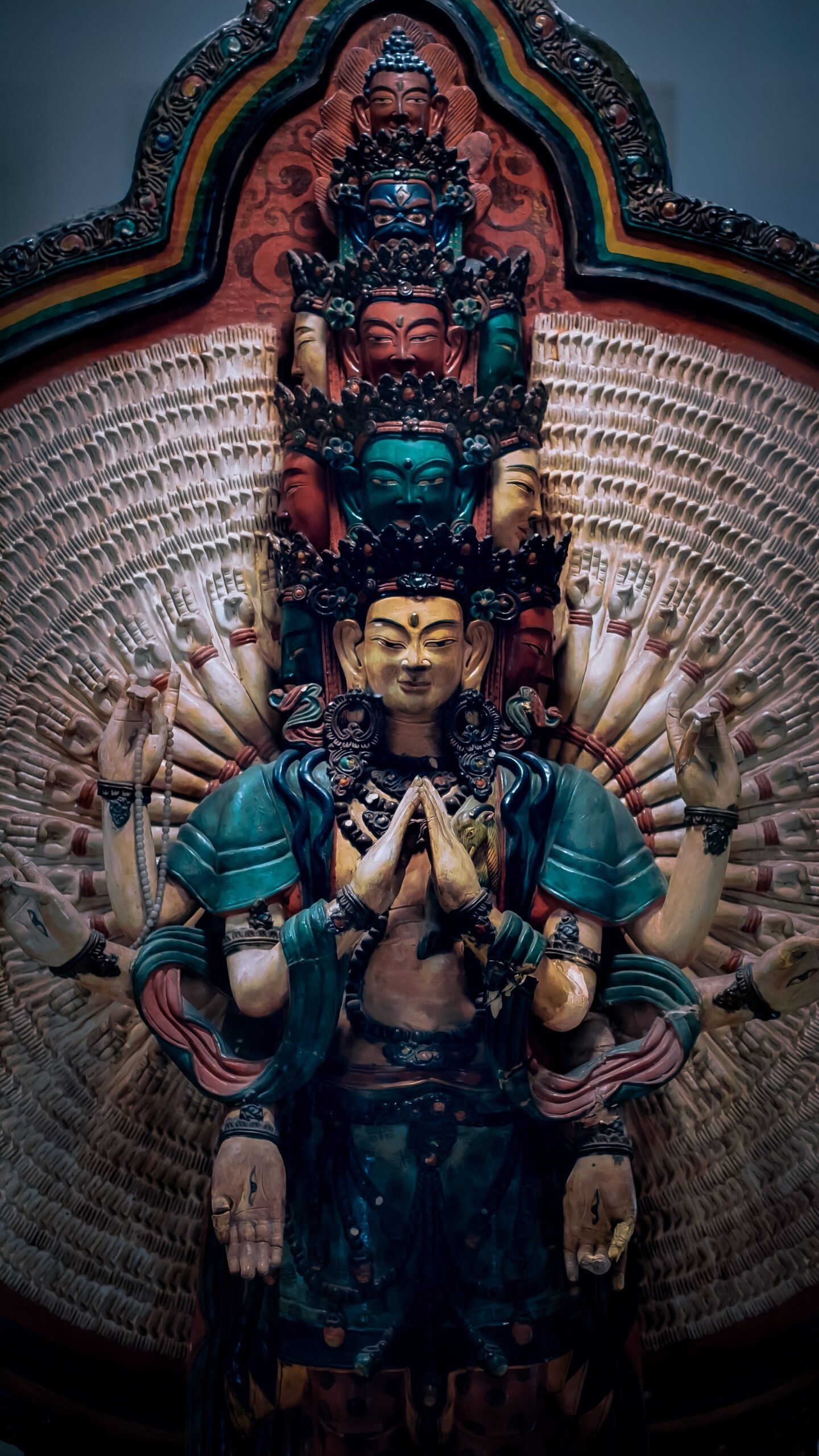 Detailed capture of a multi-armed Buddhist statue symbolizing spiritual enlightenment.